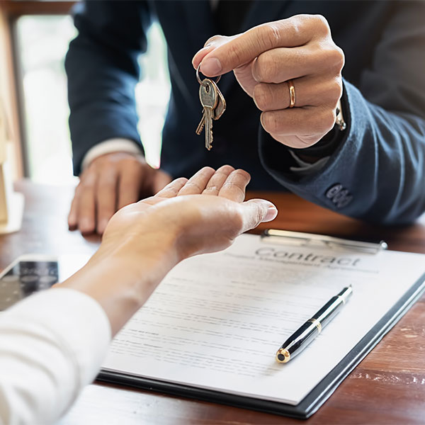 Close up of handing someone a house key